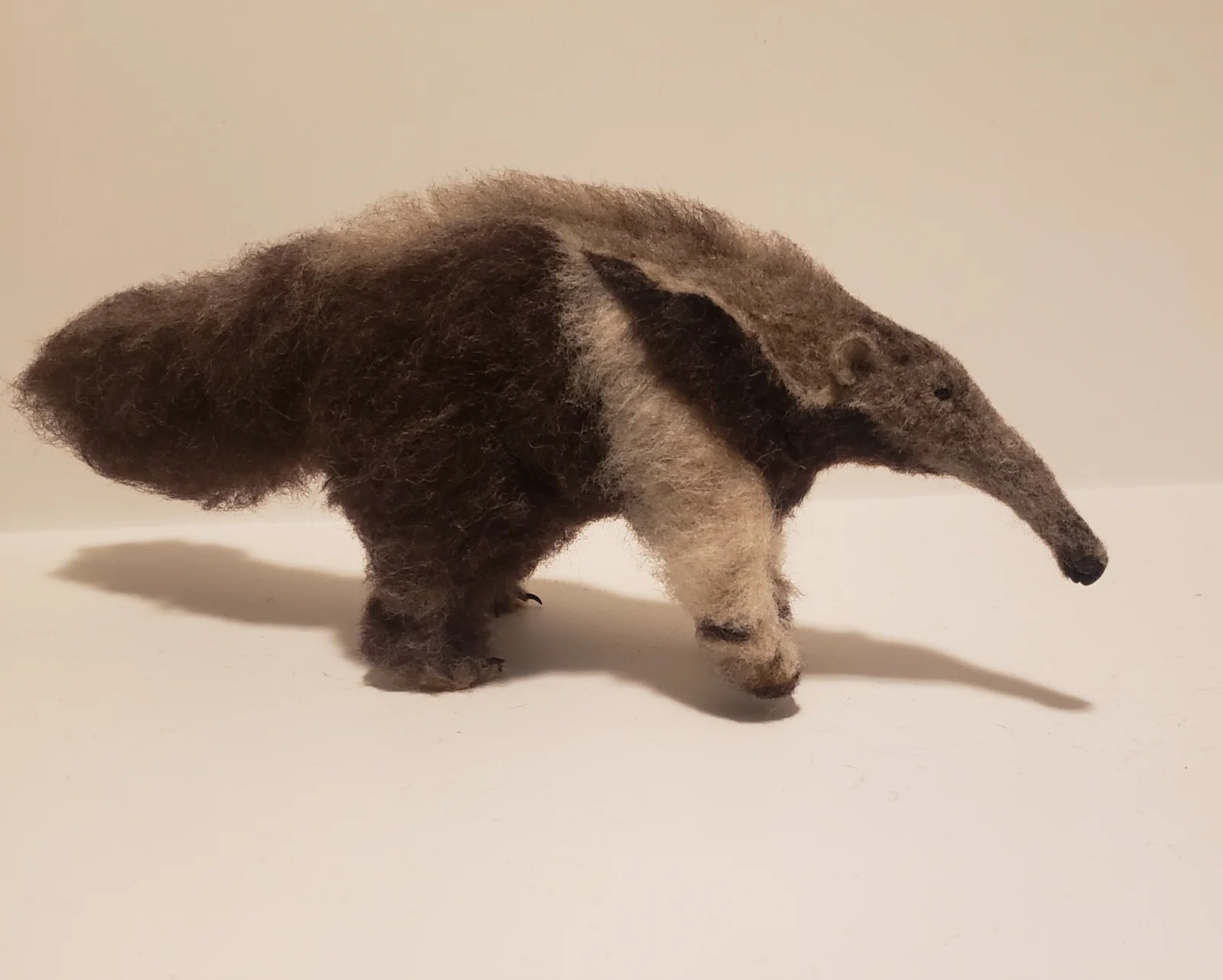 Needle-felted giant anteater with long muzzle and sweeping tail by Irina Hughes